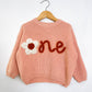 RTS 12-18 mo. pink sweater w/ “one”